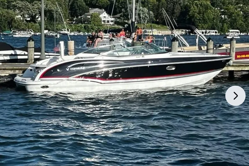  Yacht Photos Pics 2014 Formula 310 Bowrider boat docked on a sunny day by the lake.