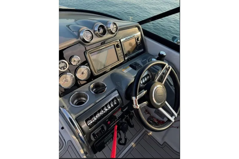  Yacht Photos Pics 2014 Formula 310 Bowrider dashboard with steering wheel and navigation instruments.