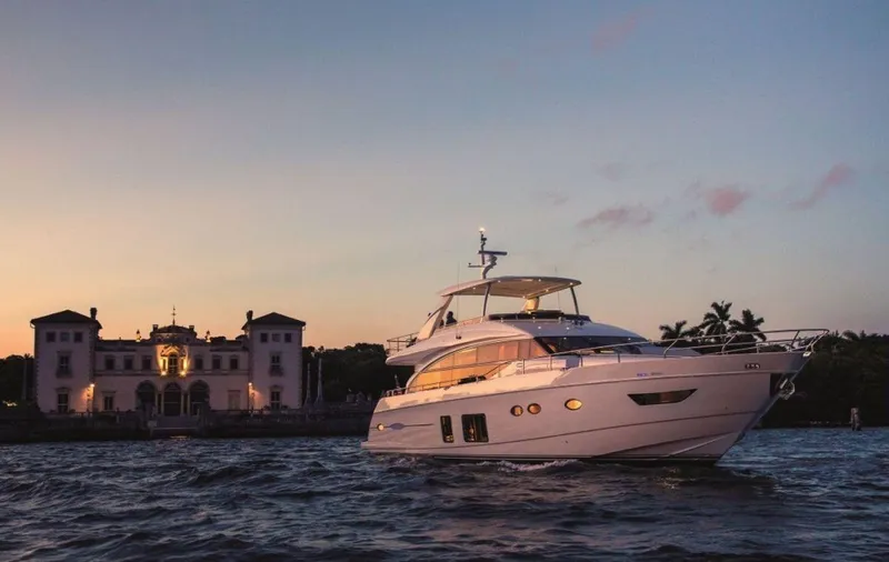  Yacht Photos Pics Luxurious 2014 Princess 82 yacht cruising at sunset near elegant waterfront mansion.