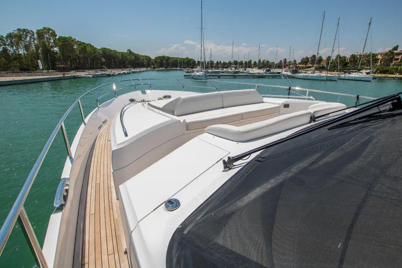  Yacht Photos Pics Luxurious 2014 Princess 82 yacht docked in a serene marina setting.