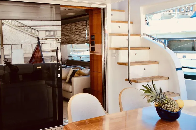  Yacht Photos Pics Luxurious interior of 2014 Princess 82 yacht with elegant dining area and staircase.