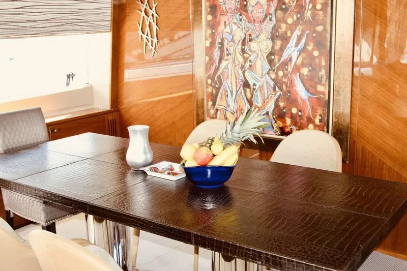  Yacht Photos Pics Luxurious dining area on 2014 Princess 82 yacht with fruit bowl and artwork.