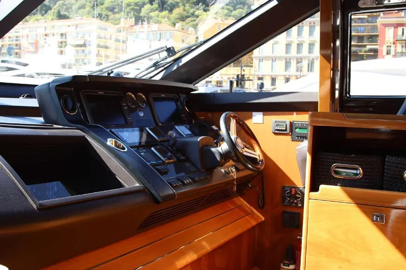  Yacht Photos Pics Luxurious 2014 Princess 82 yacht cockpit with modern navigation controls and wooden interior.