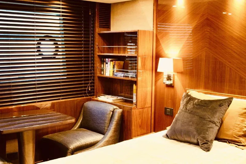  Yacht Photos Pics Luxurious cabin interior of 2014 Princess 82 yacht with wood paneling and cozy seating.