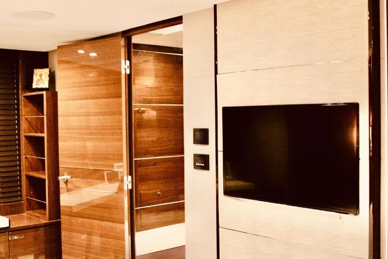  Yacht Photos Pics Luxurious interior of 2014 Princess 82 yacht with modern wood paneling and flat-screen TV.