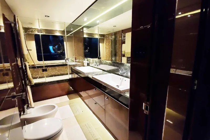  Yacht Photos Pics Luxurious bathroom interior on a 2014 Princess 82 yacht, featuring dual sinks and elegant finishes.