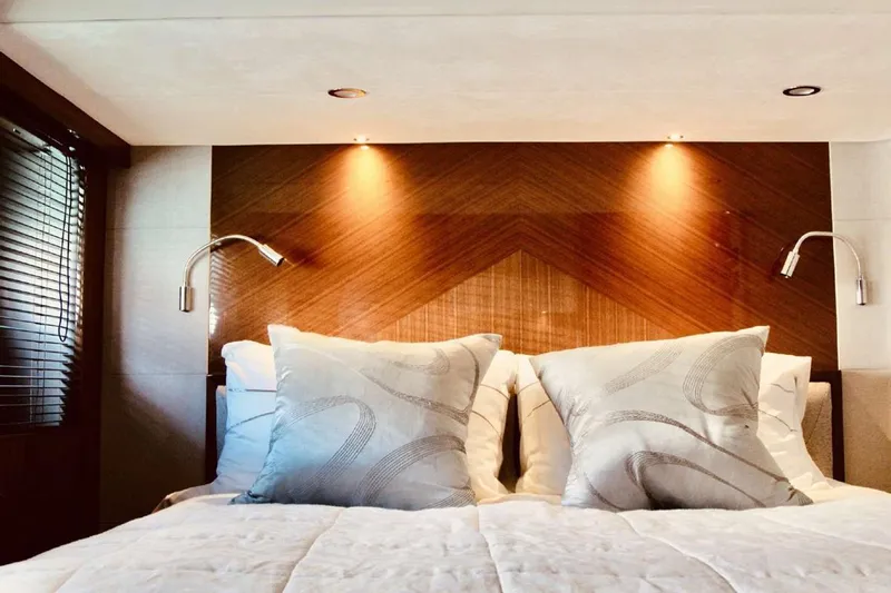  Yacht Photos Pics Luxurious bedroom interior of 2014 Princess 82 yacht with elegant lighting and plush bedding.