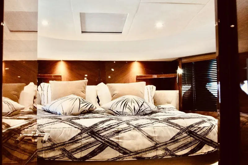  Yacht Photos Pics Luxurious bedroom interior of 2014 Princess 82 yacht with elegant bedding and ambient lighting.