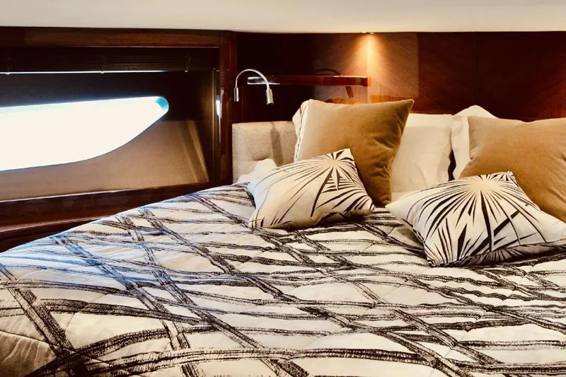  Yacht Photos Pics Luxurious bedroom interior on a 2014 Princess 82 yacht with elegant bedding and cushions.
