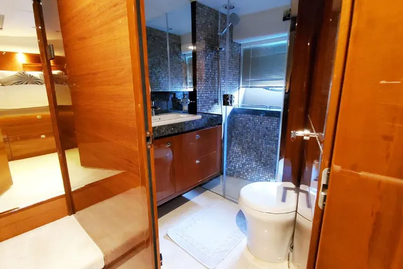  Yacht Photos Pics Luxurious bathroom interior on a 2014 Princess 82 yacht, featuring wood accents and modern fixtures.