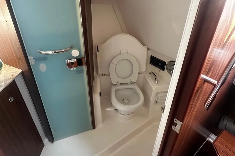  Yacht Photos Pics 2018 Pursuit OS 355 Offshore boat bathroom with toilet and modern fixtures.