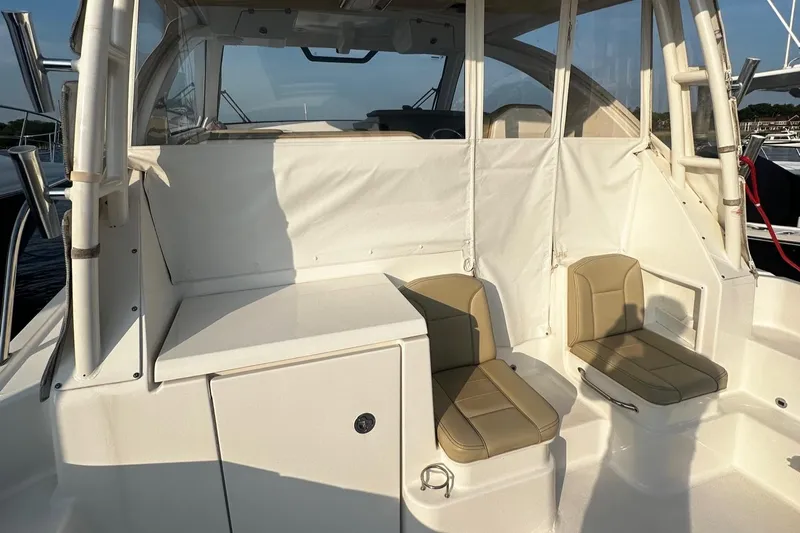  Yacht Photos Pics 2018 Pursuit OS 355 Offshore boat interior with beige seating and white paneling.
