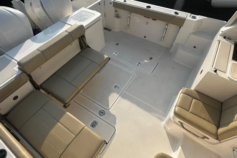  Yacht Photos Pics 2018 Pursuit OS 355 Offshore boat interior with beige seating and spacious deck layout.