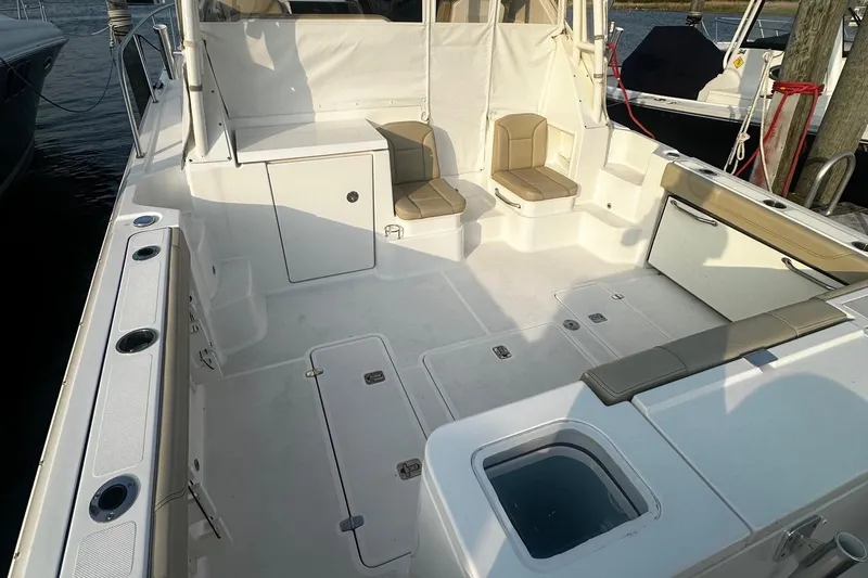  Yacht Photos Pics 2018 Pursuit OS 355 Offshore boat deck with seating and storage compartments.