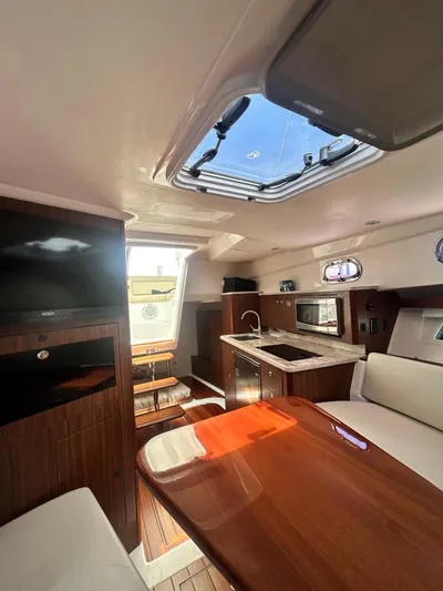  Yacht Photos Pics Interior of 2018 Pursuit OS 355 Offshore yacht with modern kitchen and seating area.