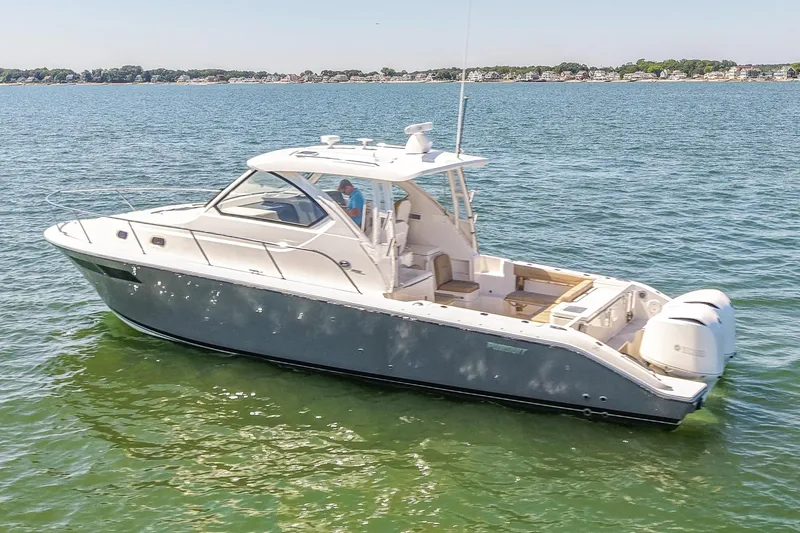  Yacht Photos Pics 2018 Pursuit OS 355 Offshore boat on calm water, side view.