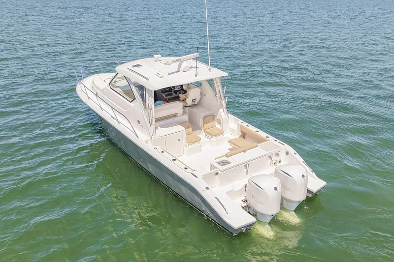  Yacht Photos Pics 2018 Pursuit OS 355 Offshore boat on calm water, rear view, twin engines visible.