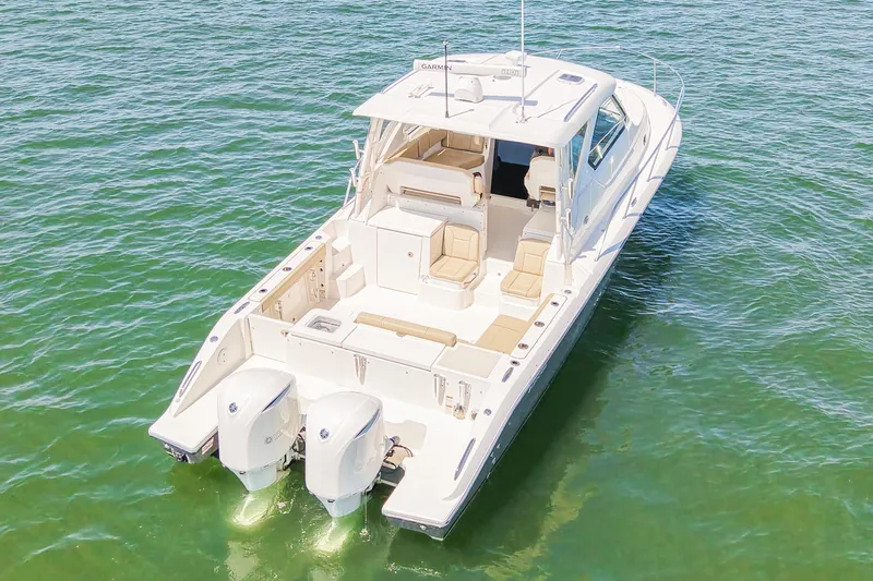  Yacht Photos Pics 2018 Pursuit OS 355 Offshore boat on clear water, showcasing spacious deck and dual engines.