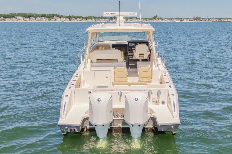  Yacht Photos Pics 2018 Pursuit OS 355 Offshore boat on water, rear view with twin engines.