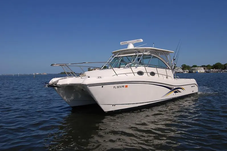 Hawks Nest Yacht Photos Pics 2014 World Cat 320 EC boat cruising on calm waters under clear blue sky.
