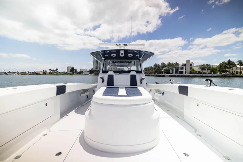  Yacht Photos Pics 2026 Freeman 47 LX boat on water, clear sky, luxury waterfront homes in background.