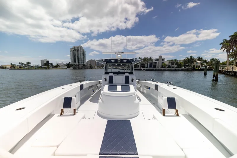  Yacht Photos Pics 2026 Freeman 47 LX boat on water with cityscape and palm trees in background.