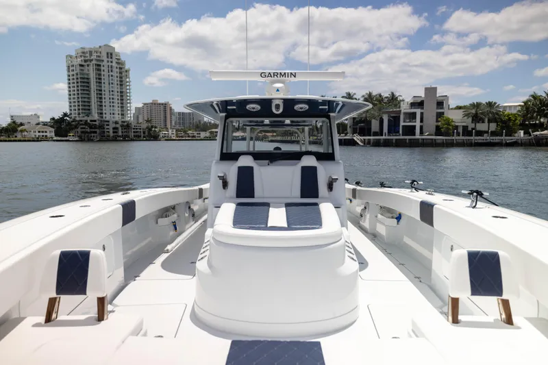  Yacht Photos Pics 2026 Freeman 47 LX boat on water, city skyline in background, clear sky.