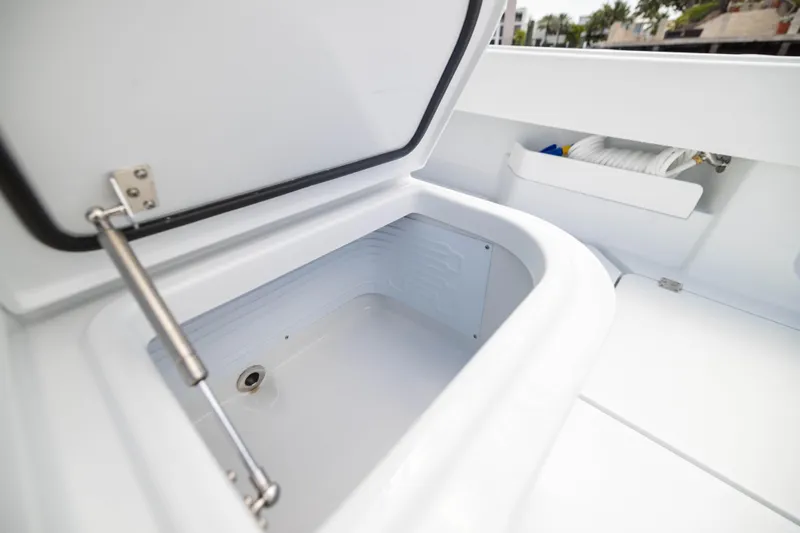  Yacht Photos Pics Open storage compartment on 2026 Freeman 47 LX boat, showcasing interior space and design.