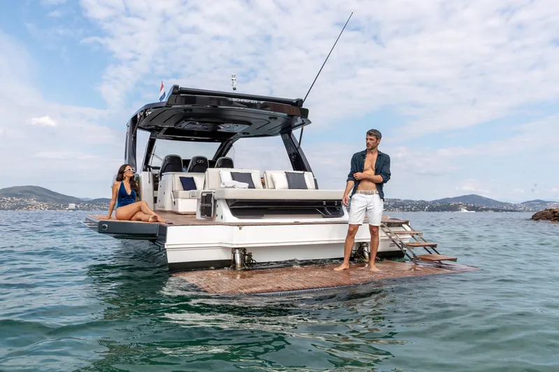  Yacht Photos Pics Luxury Schaefer V44 yacht, 2025 model, with people relaxing on the deck in scenic waters.