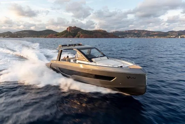  Yacht Photos Pics 2025 Schaefer V44 yacht cruising on open water with scenic mountain backdrop.