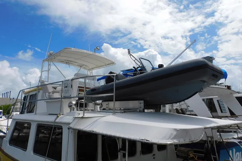 Popeye Yacht Photos Pics 1988 Hans Christian 45 Independence Trawler with dinghy on deck, under a partly cloudy sky.