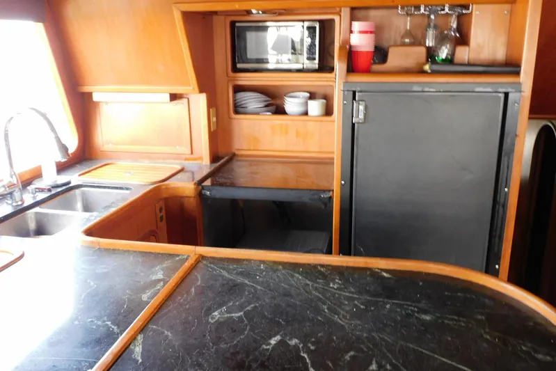 Popeye Yacht Photos Pics 1988 Hans Christian 45 Independence Trawler kitchen with sink, microwave, and storage.