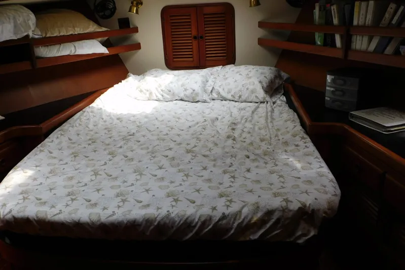 Popeye Yacht Photos Pics Cozy cabin bedroom in 1988 Hans Christian 45 Independence Trawler with nautical-themed bedding.