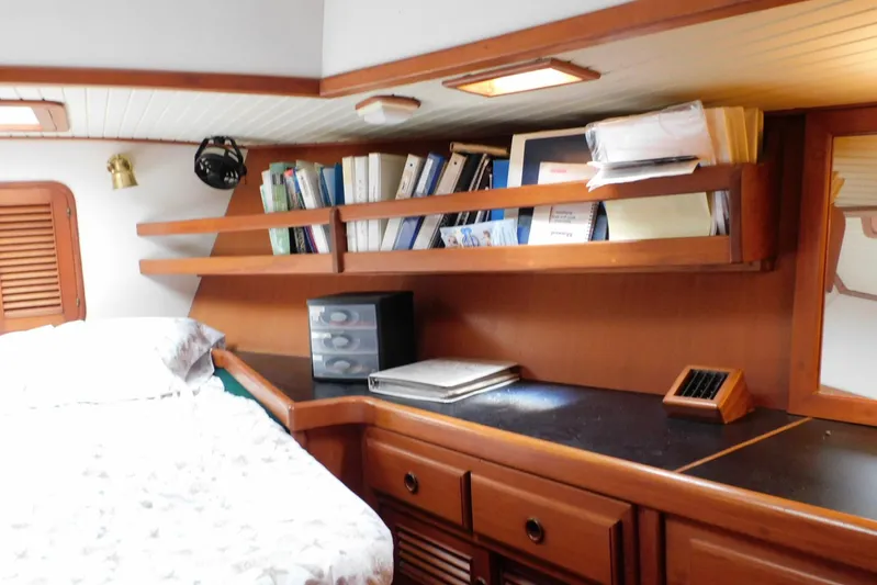 Popeye Yacht Photos Pics Cozy cabin interior of 1988 Hans Christian 45 Independence Trawler with wooden shelves and bed.