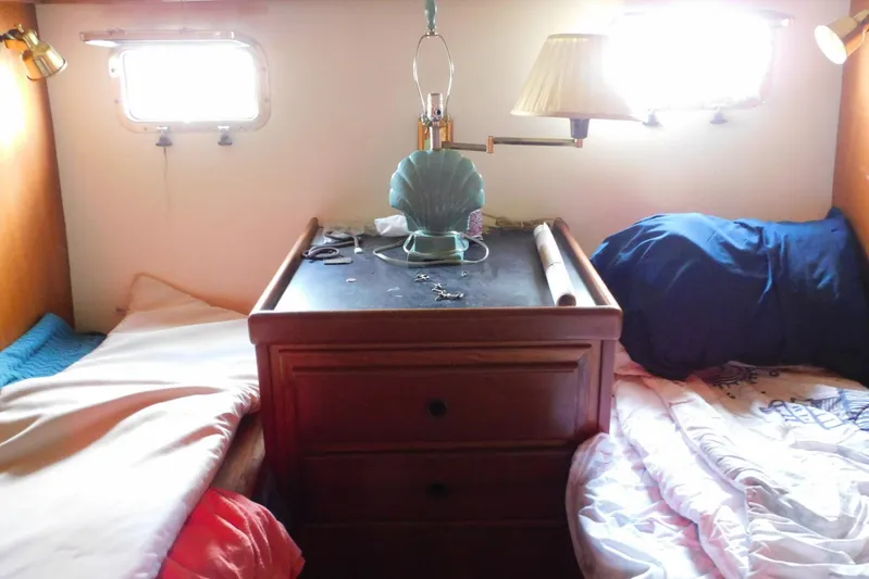 Popeye Yacht Photos Pics Cozy cabin interior of 1988 Hans Christian 45 Independence Trawler with twin beds and wooden dresser.