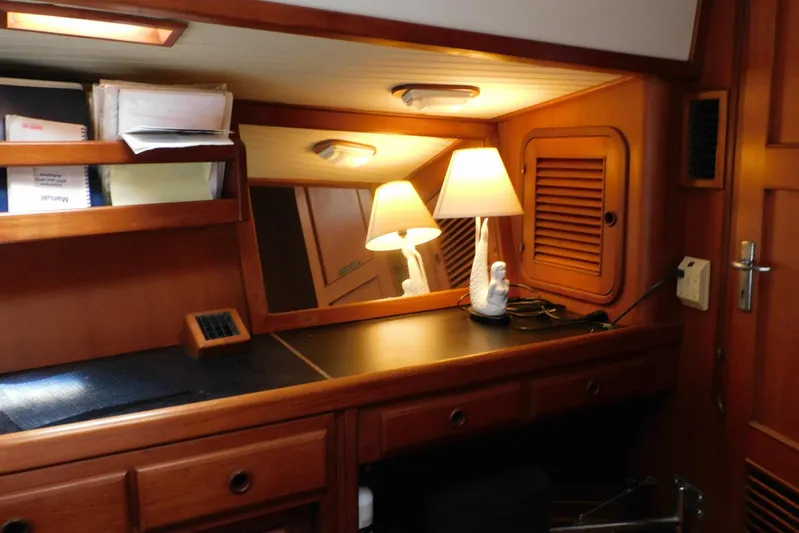 Popeye Yacht Photos Pics Cozy cabin interior of 1988 Hans Christian 45 Independence Trawler with wooden furnishings and lamp.