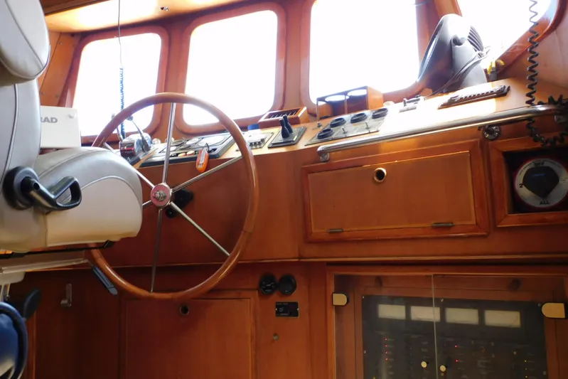 Popeye Yacht Photos Pics Interior helm of 1988 Hans Christian 45 Independence Trawler with wooden dashboard and steering wheel.