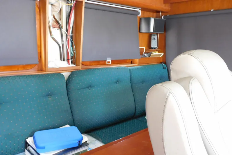 Popeye Yacht Photos Pics Interior of 1988 Hans Christian 45 Independence Trawler with teal seating and wooden accents.
