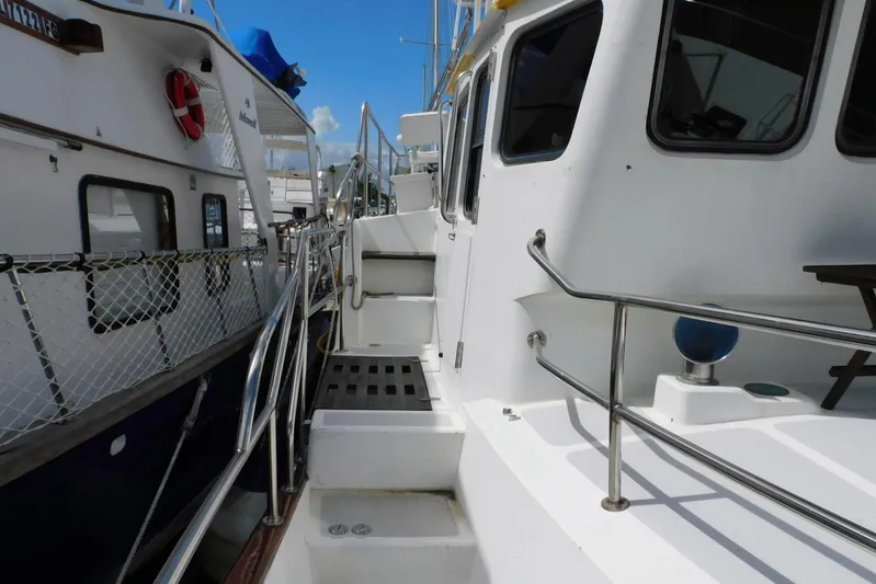 Popeye Yacht Photos Pics 1988 Hans Christian 45 Independence Trawler docked, showing side deck and railing details.