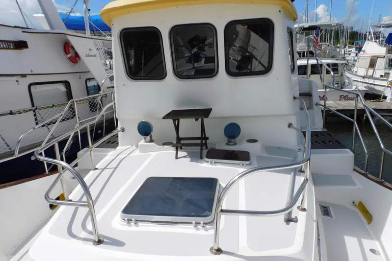 Popeye Yacht Photos Pics 1988 Hans Christian 45 Independence Trawler, white deck, docked at marina, with railing and windows.