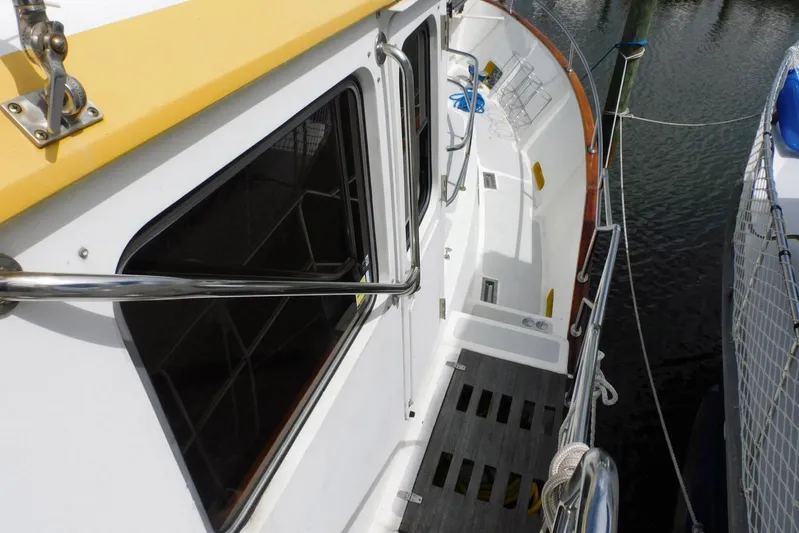 Popeye Yacht Photos Pics 1988 Hans Christian 45 Independence Trawler deck view with railing and water backdrop.