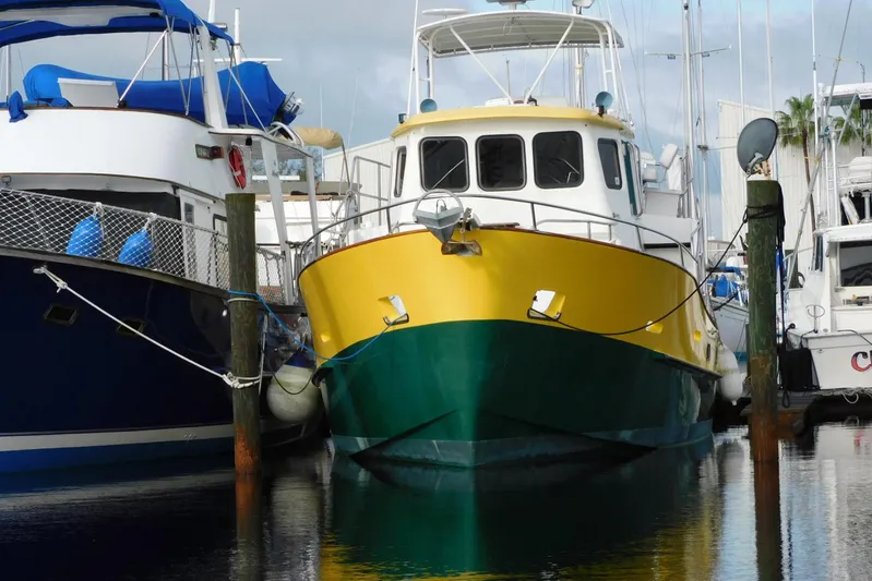 Popeye Yacht Photos Pics 1988 Hans Christian 45 Independence Trawler docked, featuring a vibrant yellow and green hull.