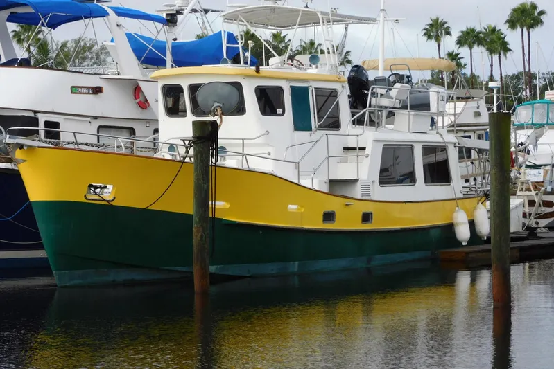 Popeye Yacht Photos Pics 1988 Hans Christian 45 Independence Trawler, yellow and green, docked in a marina.