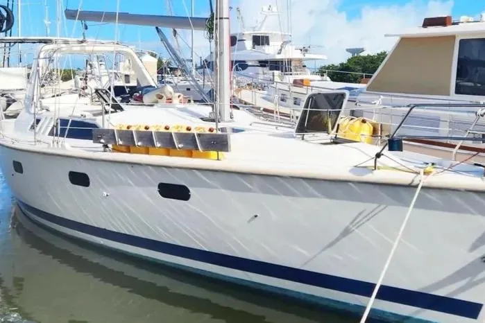 Sailboat docked in marina, 1997 Hunter 430 model, sunny day.