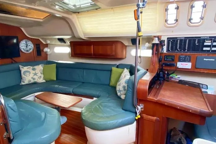 Interior of a 1997 Hunter 430 sailboat with cozy seating and navigation area.
