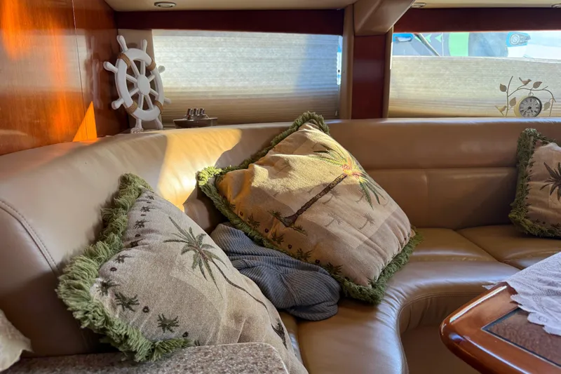 Y-knot Yacht Photos Pics Luxurious 2007 Meridian 459 Motoryacht interior with plush seating and decorative pillows.