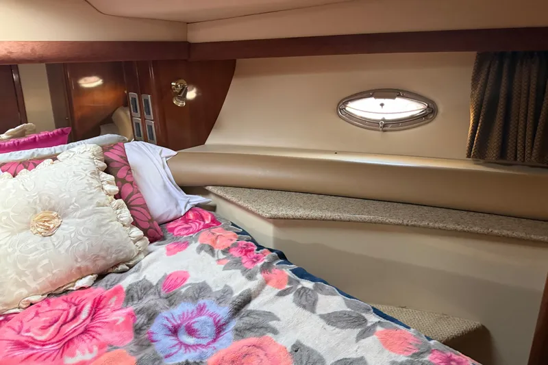 Y-knot Yacht Photos Pics Cozy bedroom interior of 2007 Meridian 459 Motoryacht with floral bedding and porthole window.