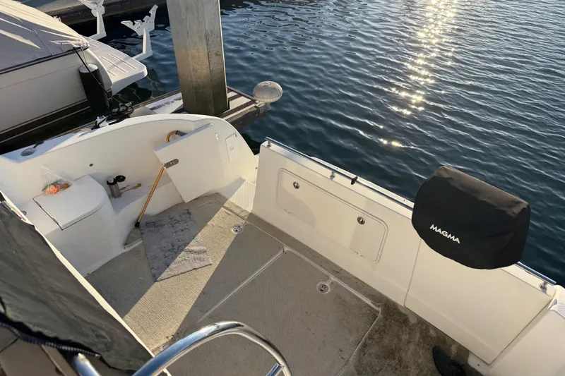 Y-knot Yacht Photos Pics 2007 Meridian 459 Motoryacht deck with dock view and Magma grill cover.