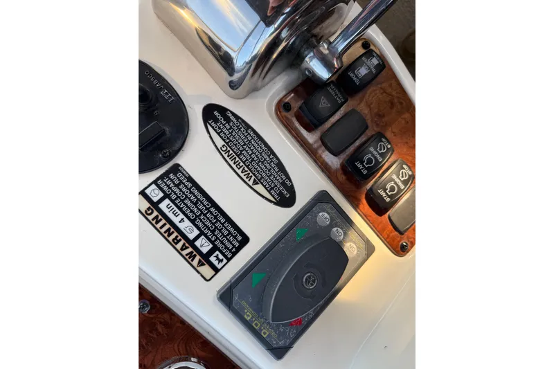 Y-knot Yacht Photos Pics Control panel of a 2007 Meridian 459 Motoryacht with warning labels and switches.