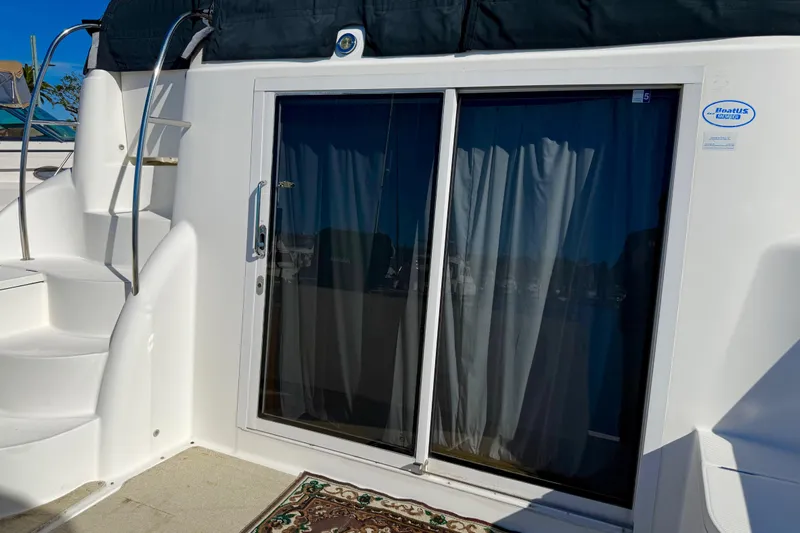 Y-knot Yacht Photos Pics 2007 Meridian 459 Motoryacht with sliding glass door and spiral staircase.